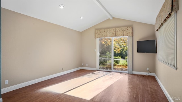 unfurnished living room with lofted ceiling with beams and wood-type flooring