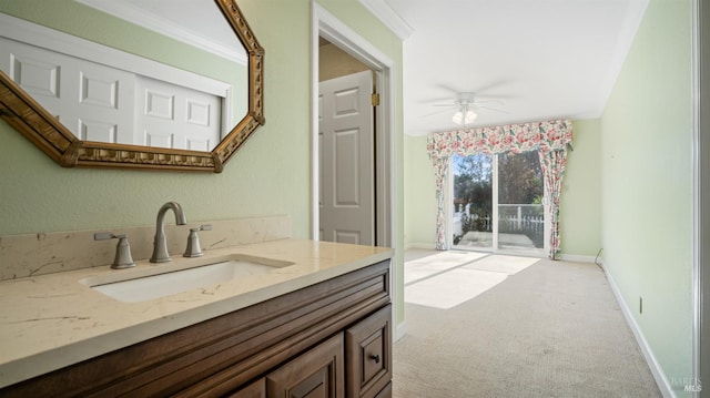 bathroom with ceiling fan, crown molding, and vanity