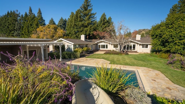 back of house with a yard and a patio area