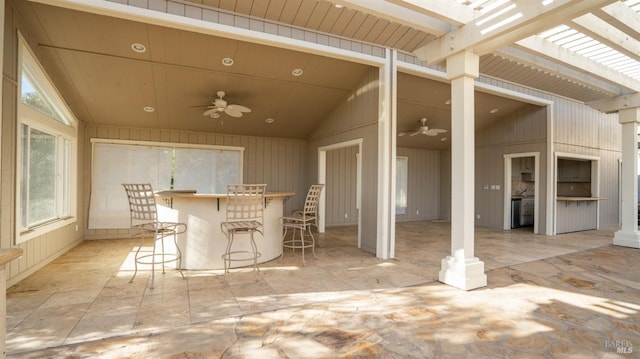 view of patio / terrace featuring ceiling fan and exterior bar