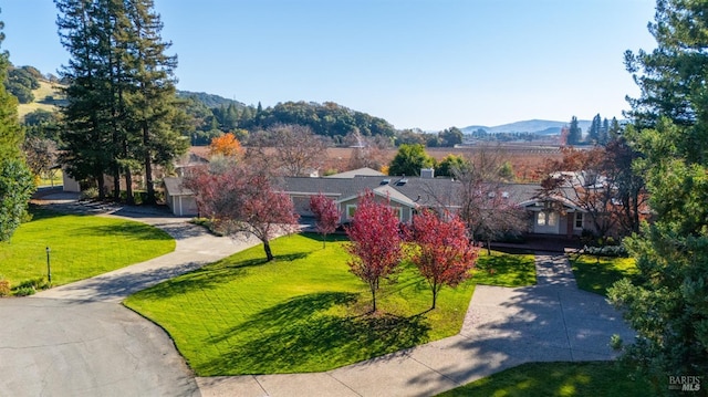 exterior space with a lawn and a mountain view