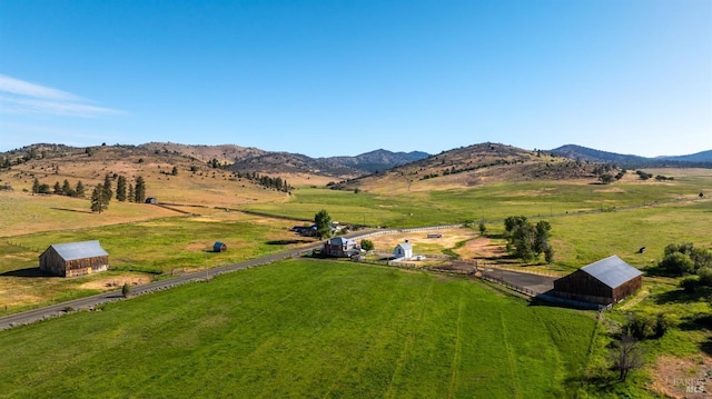 birds eye view of property with a mountain view and a rural view