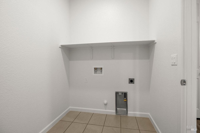 laundry room with hookup for an electric dryer, washer hookup, gas dryer hookup, and light tile patterned flooring