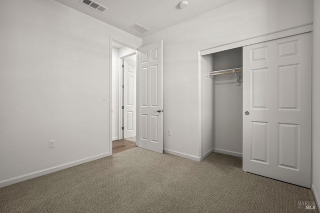 unfurnished bedroom with a closet and carpet