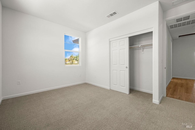 unfurnished bedroom with carpet and a closet