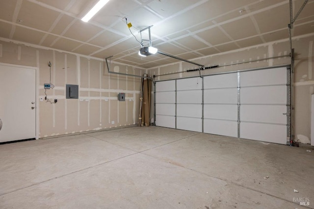 garage featuring electric panel and a garage door opener