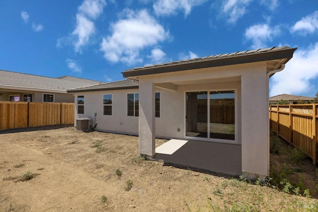 rear view of house featuring cooling unit