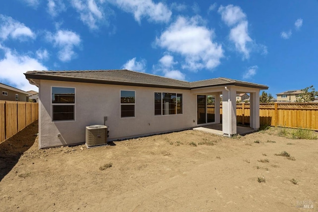 back of property with a patio area and cooling unit