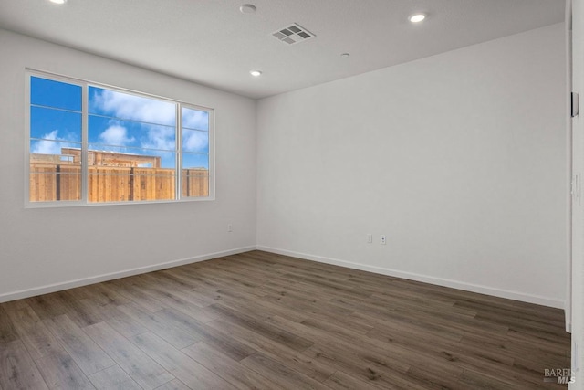 spare room with dark hardwood / wood-style floors