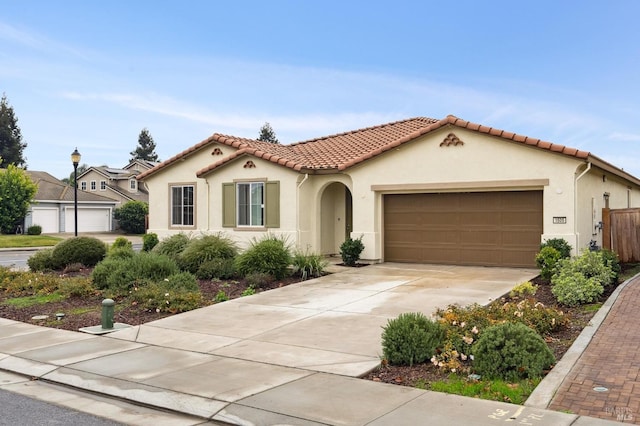 mediterranean / spanish house featuring a garage