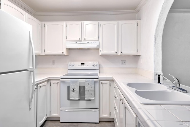 kitchen featuring white cabinetry, sink, tile countertops, crown molding, and white appliances