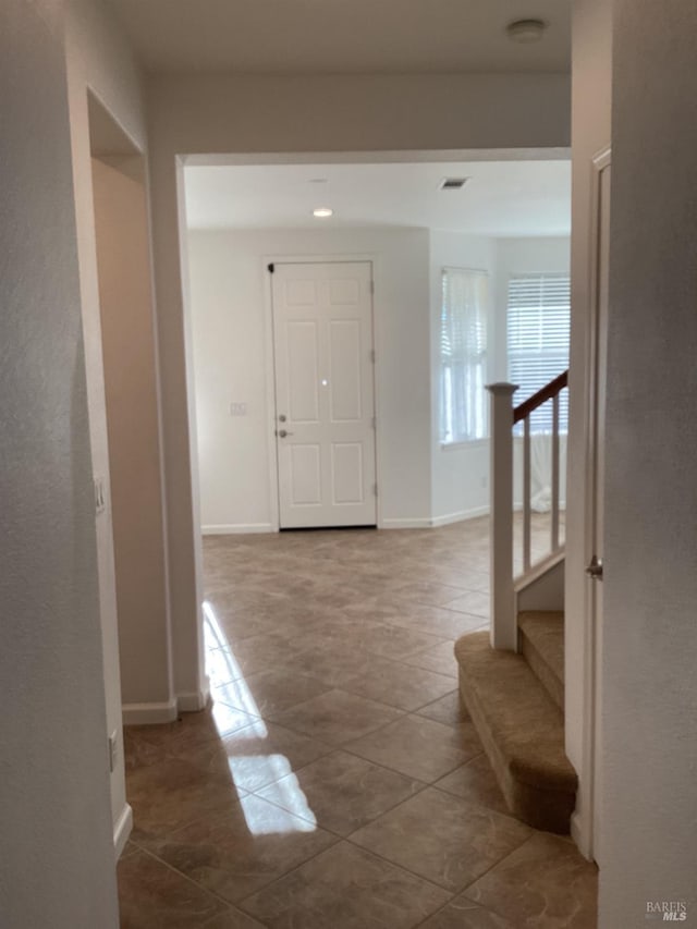 hall featuring tile patterned flooring