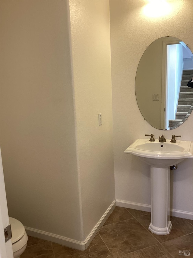 bathroom featuring tile patterned floors, sink, and toilet