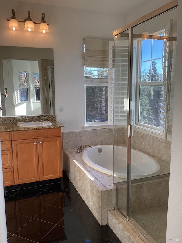 bathroom with shower with separate bathtub, tile patterned floors, and vanity