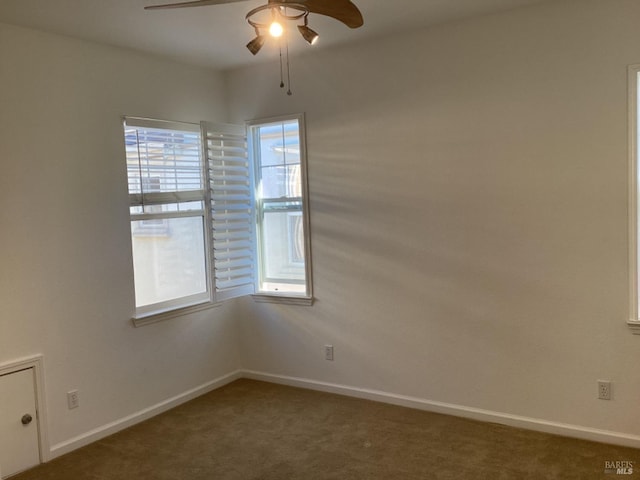 carpeted spare room featuring ceiling fan