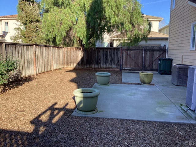 view of yard featuring central AC unit and a patio