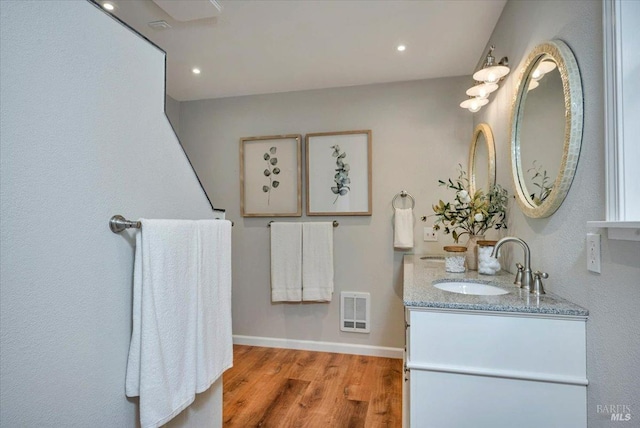 bathroom with hardwood / wood-style floors and vanity