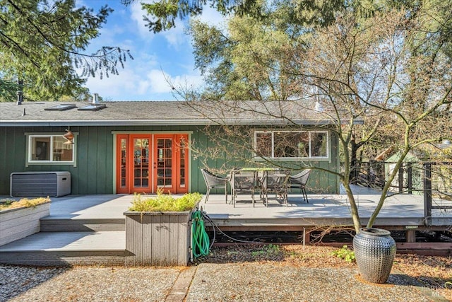 rear view of property featuring french doors and a deck