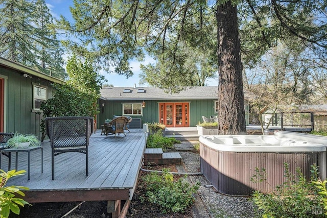 deck featuring french doors and a hot tub