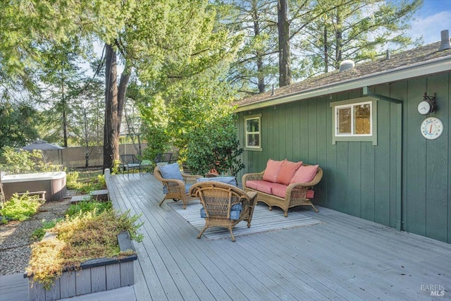 deck featuring outdoor lounge area and a hot tub