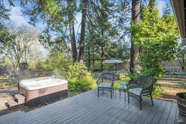 wooden terrace featuring a hot tub