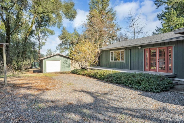 ranch-style home featuring an outbuilding and a garage