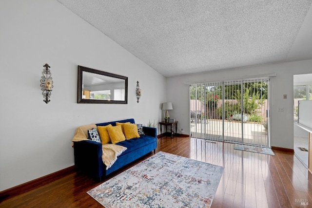 living area with baseboards, a textured ceiling, lofted ceiling, and wood finished floors