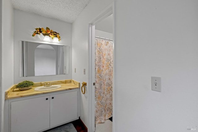bathroom featuring vanity and a textured ceiling