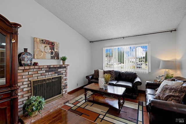living room with a textured ceiling, wood finished floors, lofted ceiling, and a fireplace