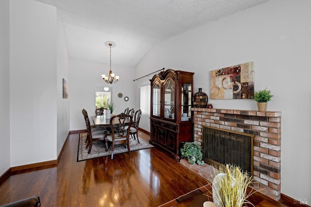 dining space featuring dark wood-style flooring, baseboards, and lofted ceiling