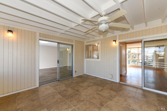 spare room featuring ceiling fan and beam ceiling