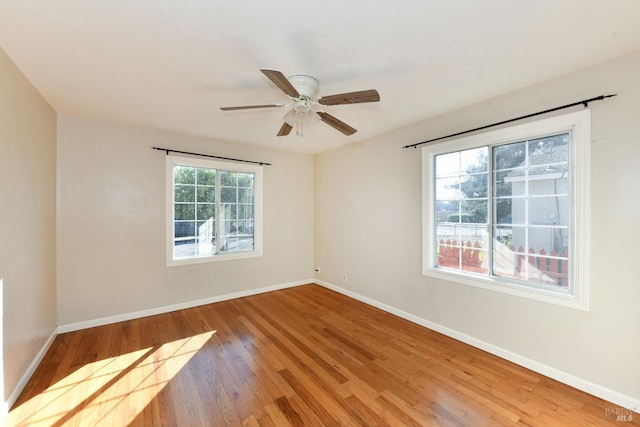 empty room featuring ceiling fan and light hardwood / wood-style floors