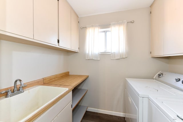 laundry room with washer and dryer, sink, and cabinets