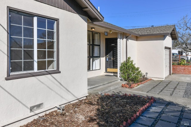 doorway to property with a garage