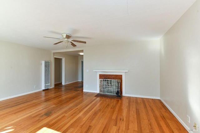 unfurnished living room with ceiling fan and hardwood / wood-style floors