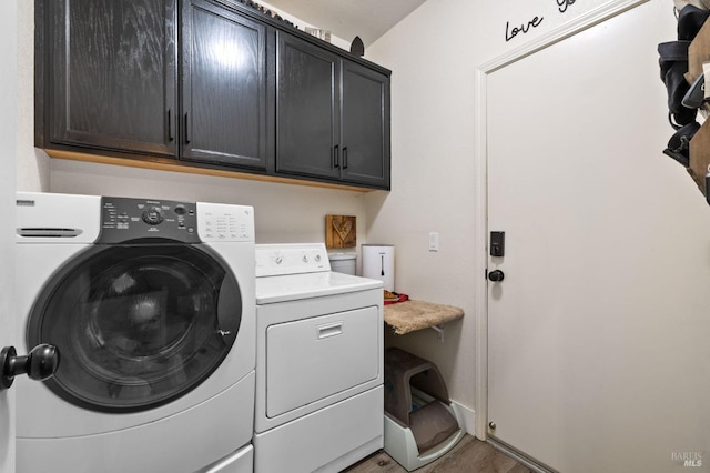 laundry area featuring cabinets and washing machine and dryer