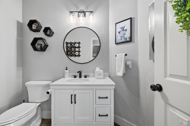 bathroom featuring vanity and toilet