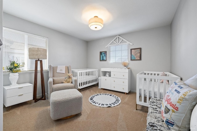 bedroom featuring carpet, a crib, and multiple windows