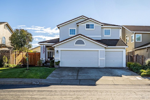 view of property with a garage and a front yard