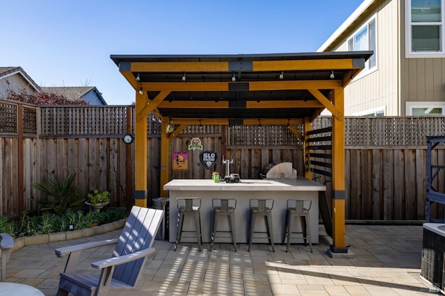 view of patio featuring a gazebo and a bar