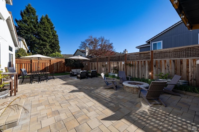 view of patio featuring an outdoor living space with a fire pit