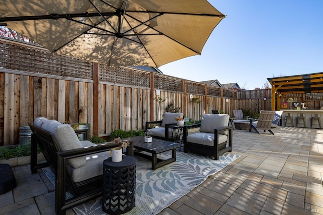 view of patio / terrace with an outdoor living space with a fire pit