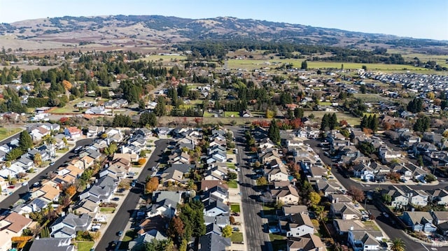 birds eye view of property featuring a mountain view