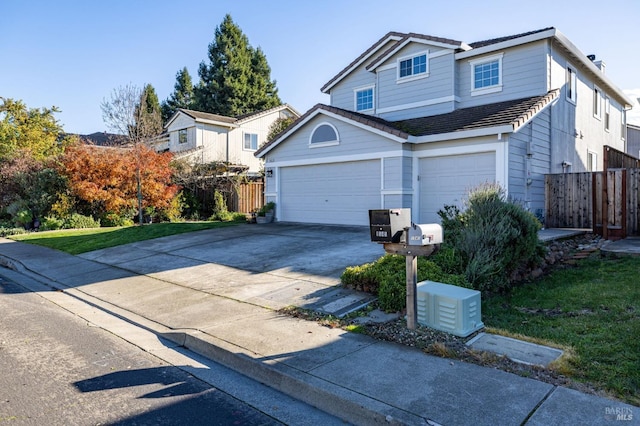 view of front of house with a garage and a front lawn