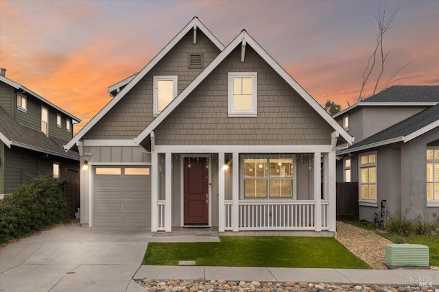 view of front of property with an attached garage, board and batten siding, covered porch, and driveway