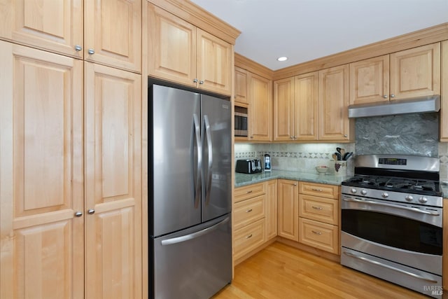 kitchen featuring light brown cabinets, light stone counters, light hardwood / wood-style flooring, decorative backsplash, and appliances with stainless steel finishes