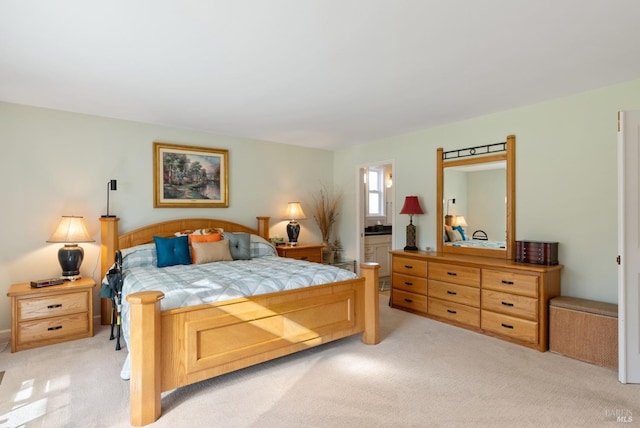 carpeted bedroom featuring ensuite bath