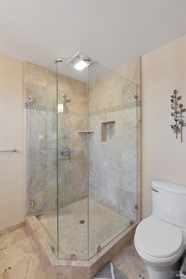 bathroom with toilet and walk in shower