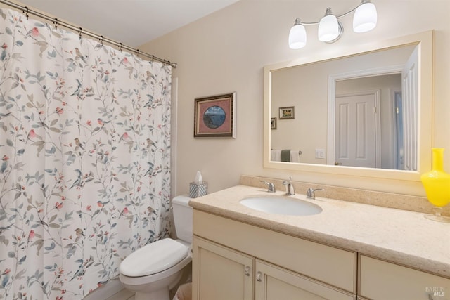 bathroom with walk in shower, vanity, and toilet