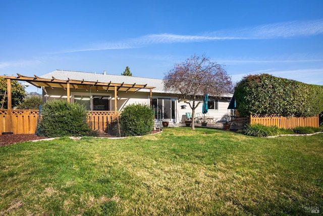 rear view of property with a pergola and a yard